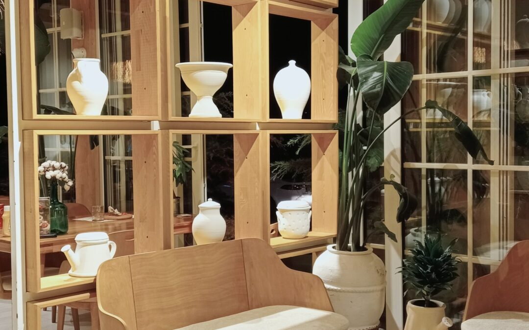 Image of interior design with wood, plants, lighting, and uniquely shaped furniture and decor