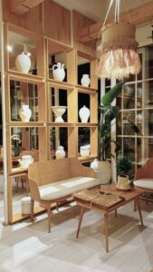Image of interior design with wood, plants, lighting, and uniquely shaped furniture and decor